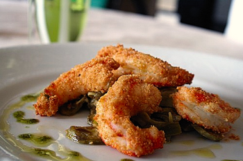 gamberoni con panatura di granella nocciole su letto d carciofi