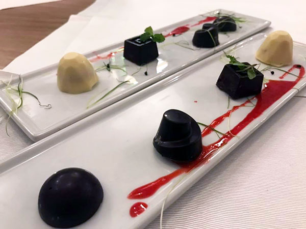 Il pre dessert: cioccolatini assortiti, alcuni con confettura di datterino e cappero